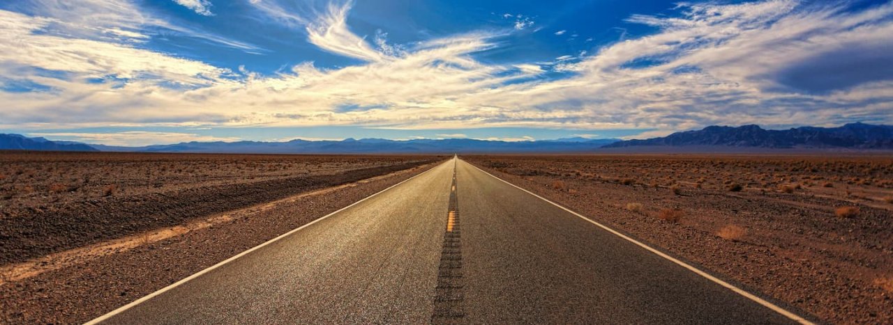 A symbolic road and sky with an open horizon, possibly in the Americas, representing the group of En-route courses at All Nations.
