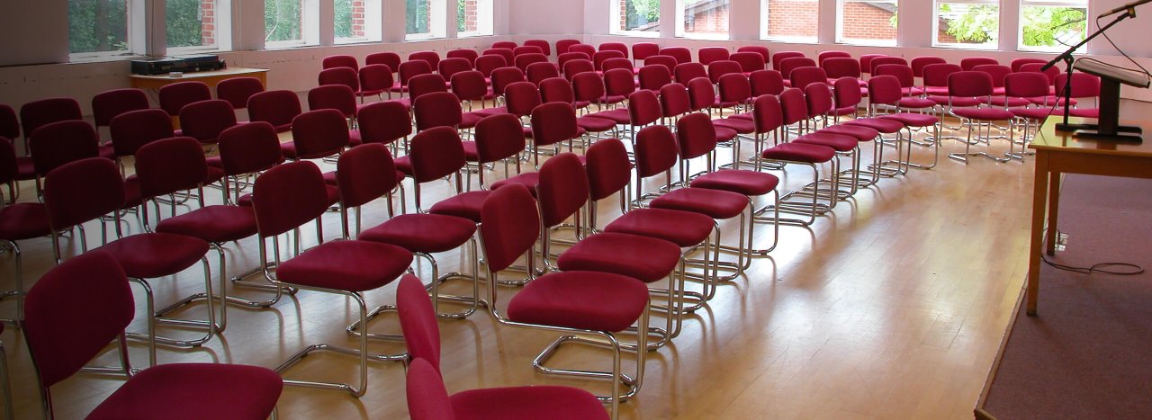 A series of chairs in a conference hall, exemplifying All Nation's multiple conferencing rooms.