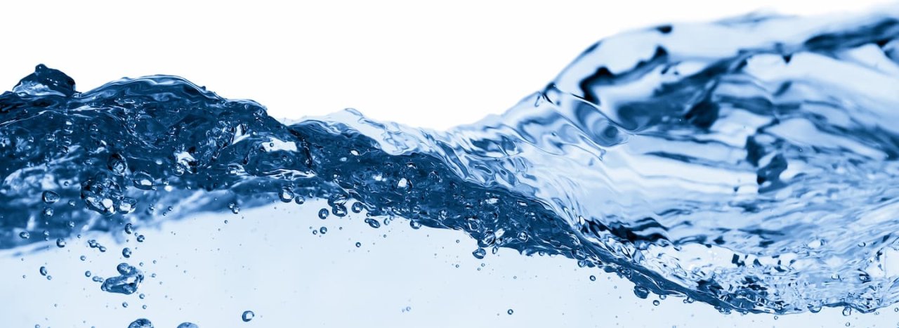A burst splash of water, highlighted in blue, representing the Refresh course retreat at All Nations.